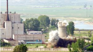 A North Korean nuclear plant is seen before demolishing a cooling tower (R) in Yongbyon