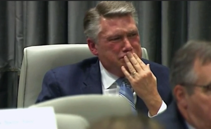 Congressional candidate displays emotion in ballot fraud hearing.