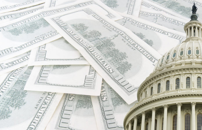 The U.S. Capitol against a backdrop of dollars.