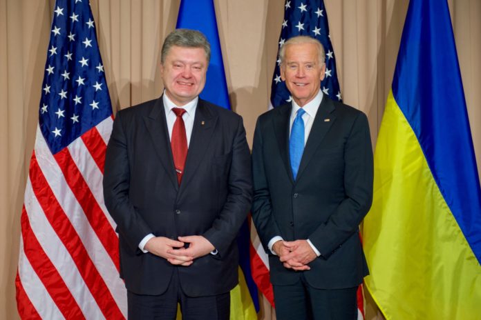 Vice President Joe Biden stands with Ukrainian President Petro Poroshenko with a Ukrainian and American flag in the background
